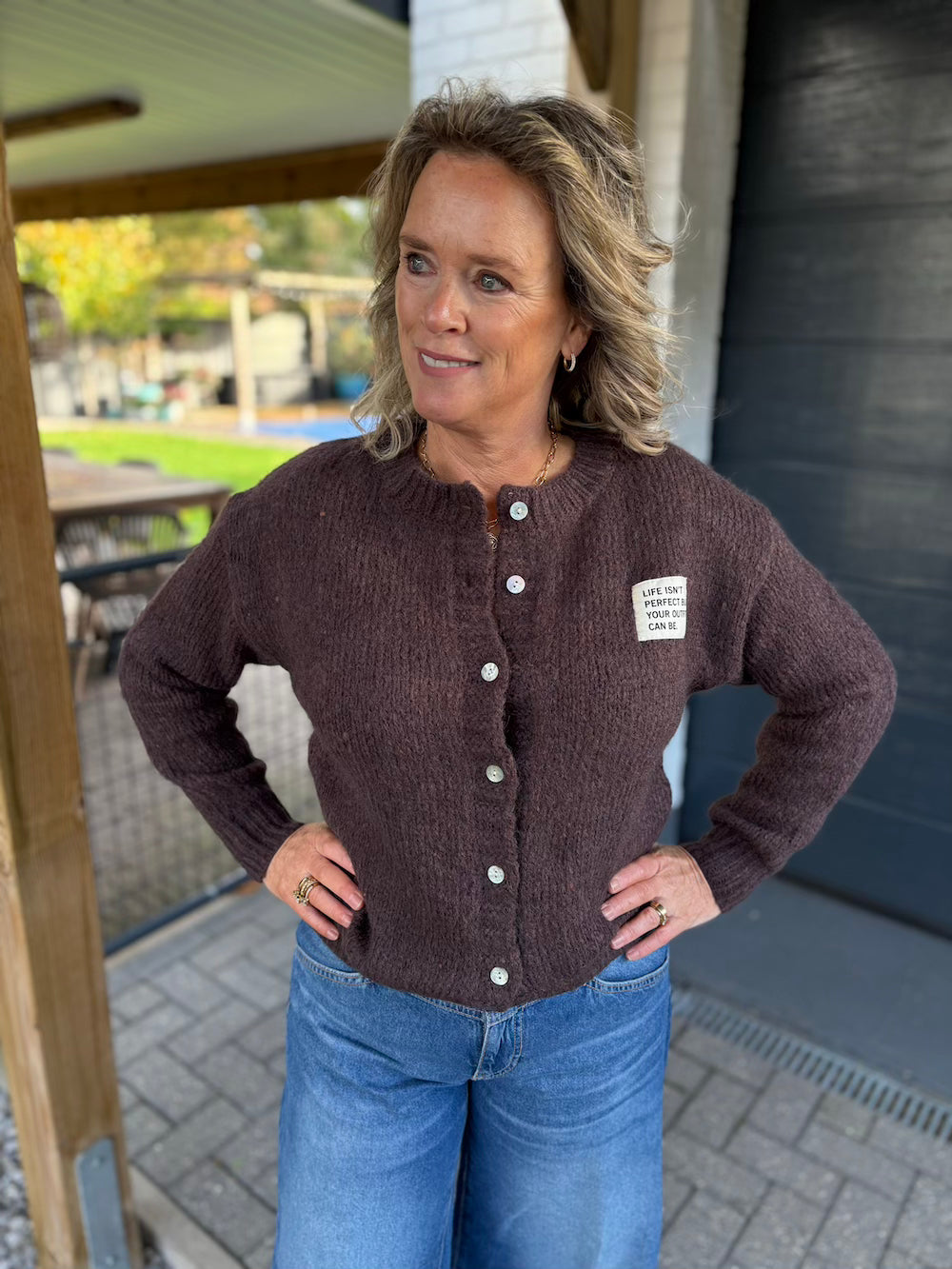 Vestje bruin met quote life isn't perfect but your outfit can be